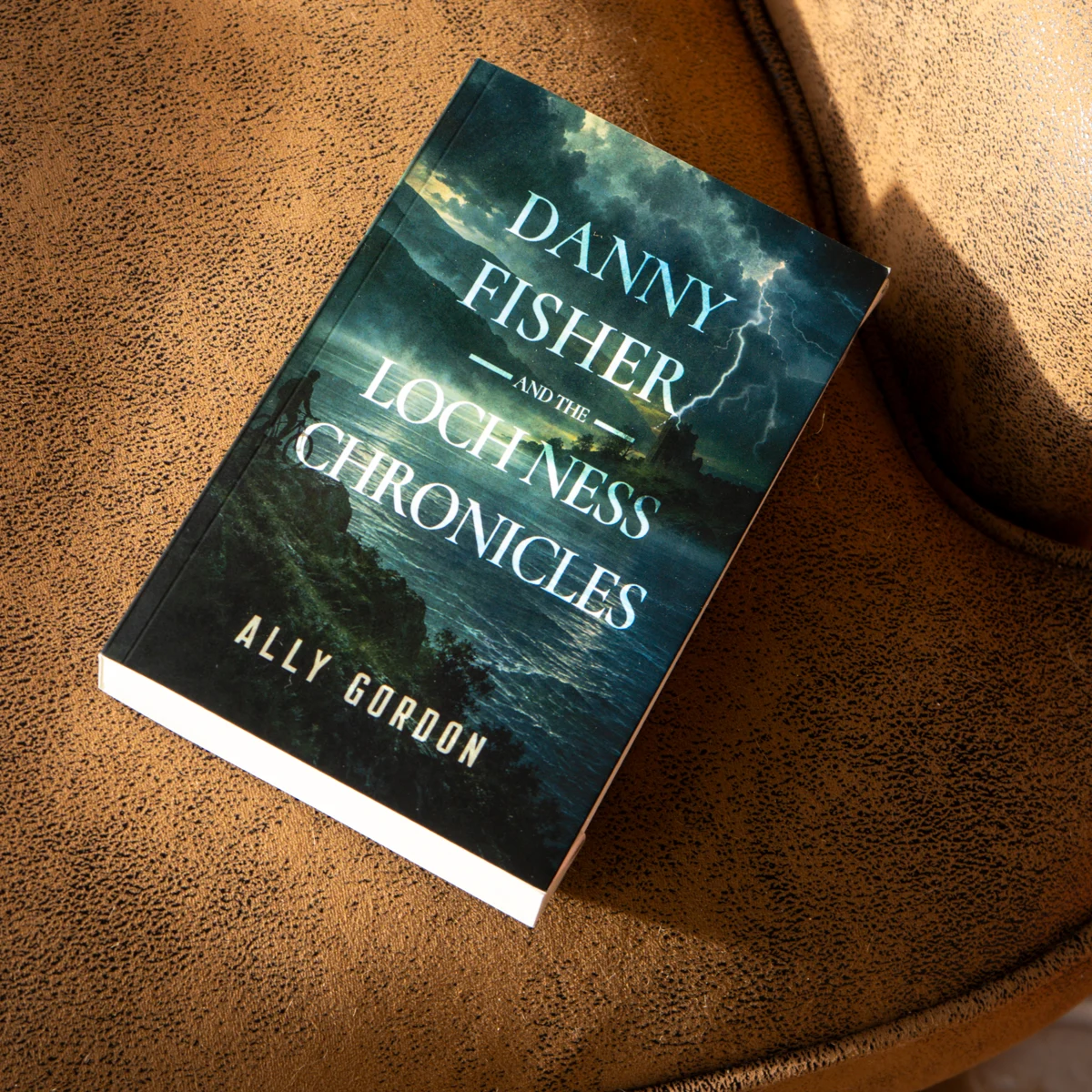 Danny Fisher resting on a brown leather armchair